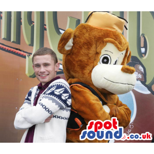 Brown and fluffy monkey mascot with amiable smile and eyes