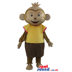 Brown monkey wearing brown trousers and a yellow t-shirt -