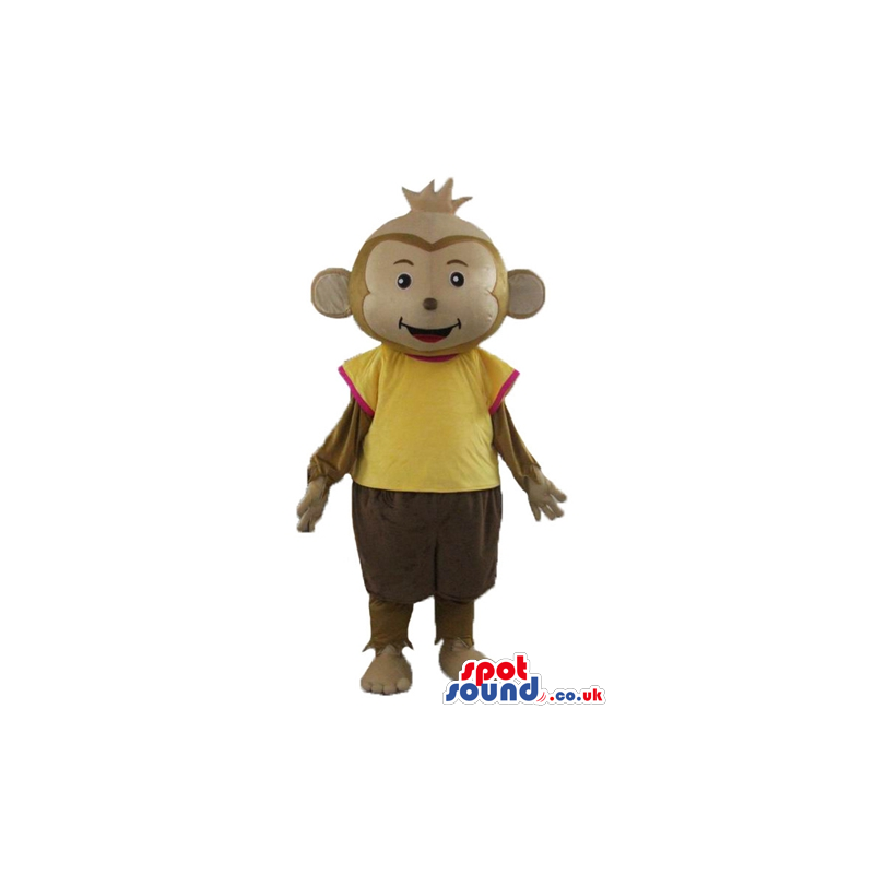 Brown monkey wearing brown trousers and a yellow t-shirt -