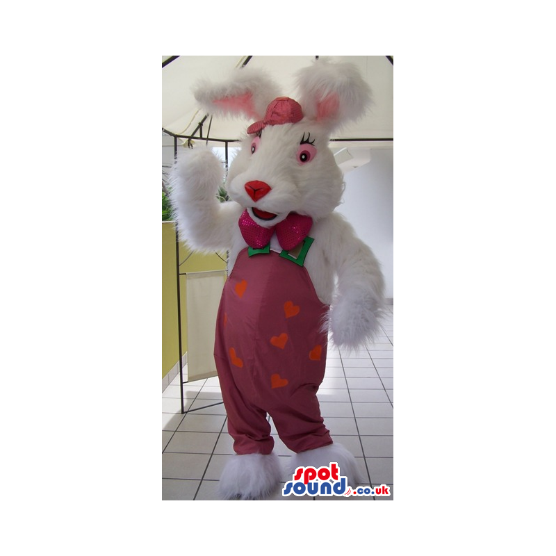 Fluffy white rabbit mascot with pink trousers, bow tie and cap