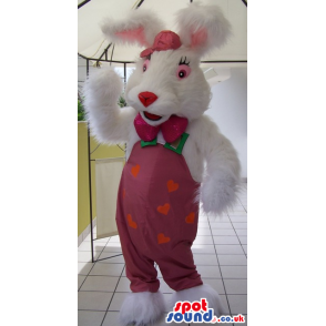 Fluffy white rabbit mascot with pink trousers, bow tie and cap