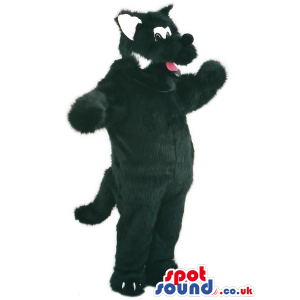 Overjoyed black wolf mascot with long tail and white ears