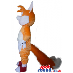 Smiling orange and white fox wearing red shoes - Custom Mascots