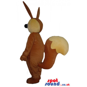 Brown and yellow rabbit with large teeth and a big nose. -