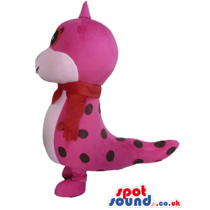 Pink and red dragon with a violet tongue wearing a red scarf -
