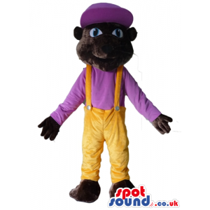 Brown monkey wearing yellow trousers and a purple t-shirt and