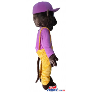 Brown monkey wearing yellow trousers and a purple t-shirt and