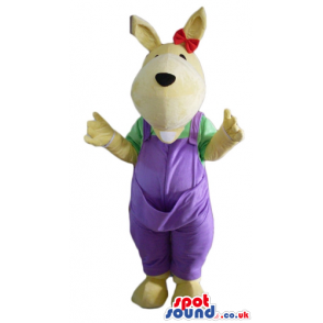 Beige dog wearing a green shirt, purple gardener trousers and