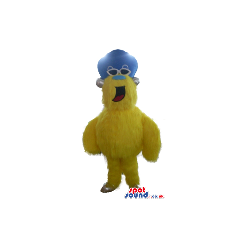 Yellow furry monster with a light blue nose wearing dark