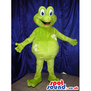 Green happy frog mascot with big blue eyes and adorable smile -