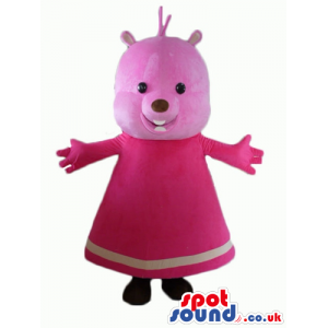 Pink bear with small black eyes wearing a long pink dress -