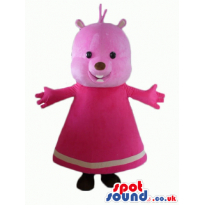 Pink bear with small black eyes wearing a long pink dress -