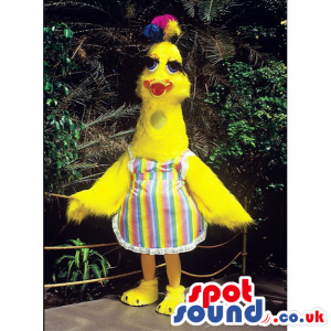 Yellow bird mascot with long neck, blue eyes and colorful apron