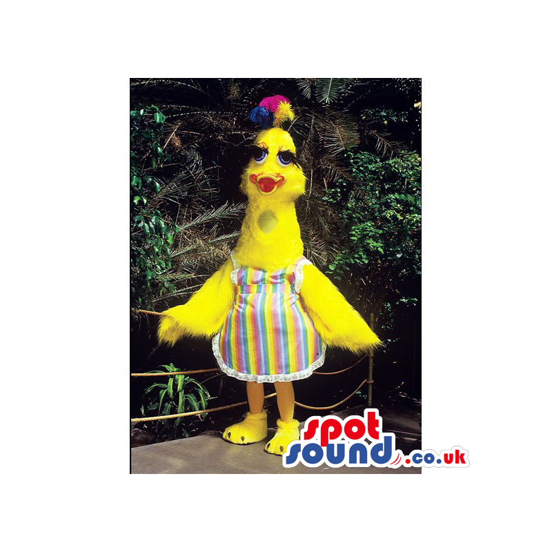Yellow bird mascot with long neck, blue eyes and colorful apron