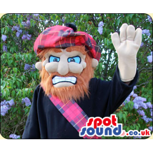 Irritated looking bearded scotman mascot with huge checkered