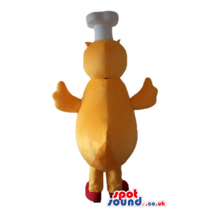 Yellow chicken with a red beak and feet wearing a chef's hat -