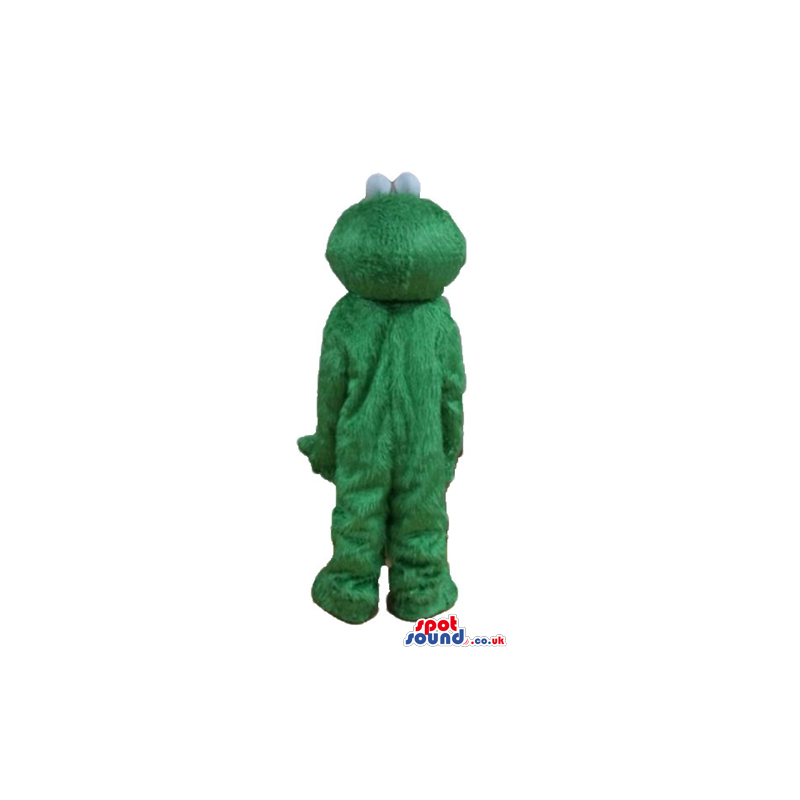 Green furry monster with a round yellow nose and round eyes
