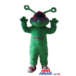 Green monster with antennae wearing violet glasses, a red cap