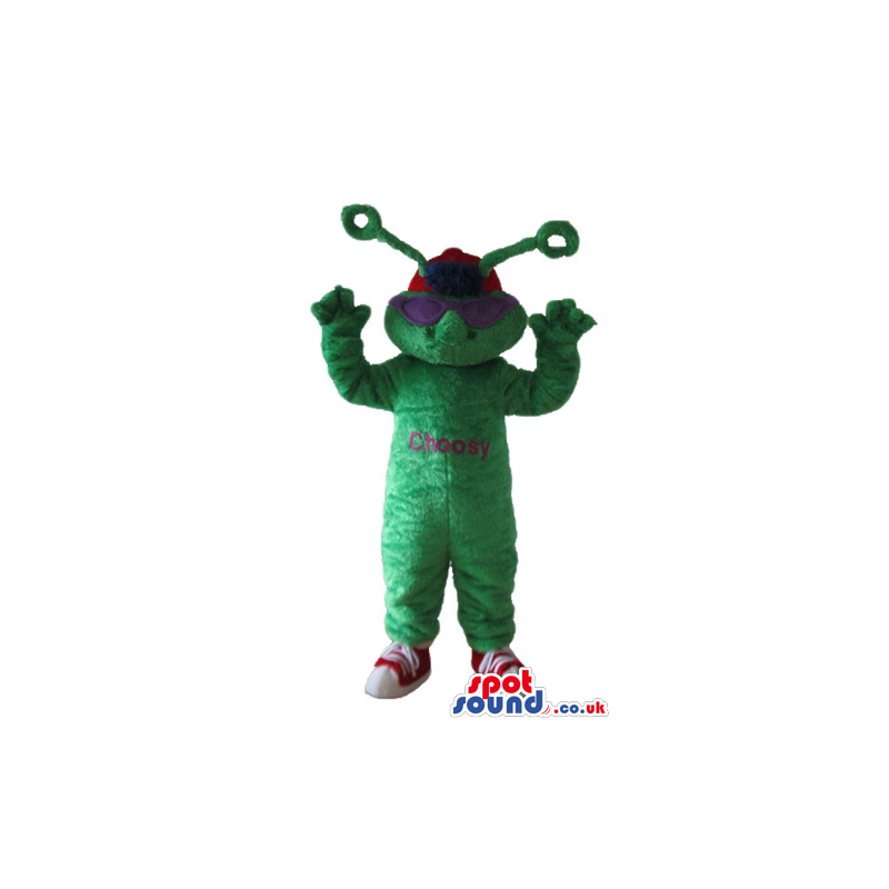 Green monster with antennae wearing violet glasses, a red cap