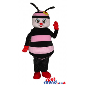 Pink and black bee with black arms and legs wearing red gloves