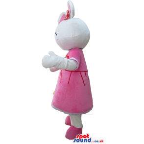 White rabbit with pink ears wearing a red flower on the head, a