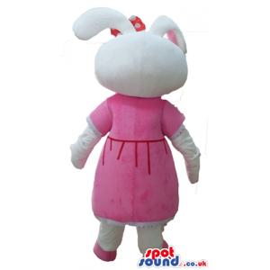 White rabbit with pink ears wearing a red flower on the head, a