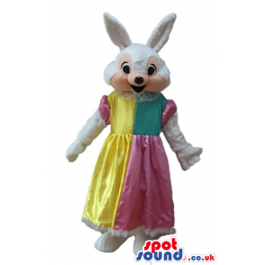 White rabbit wearing a long yellow, pink and green dress -
