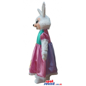 White rabbit wearing a long yellow, pink and green dress -