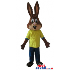 Brown rabbit wearing a yellow t-shirt and blue trousers -