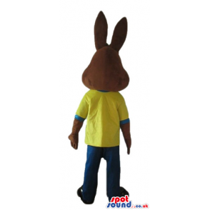 Brown rabbit wearing a yellow t-shirt and blue trousers -