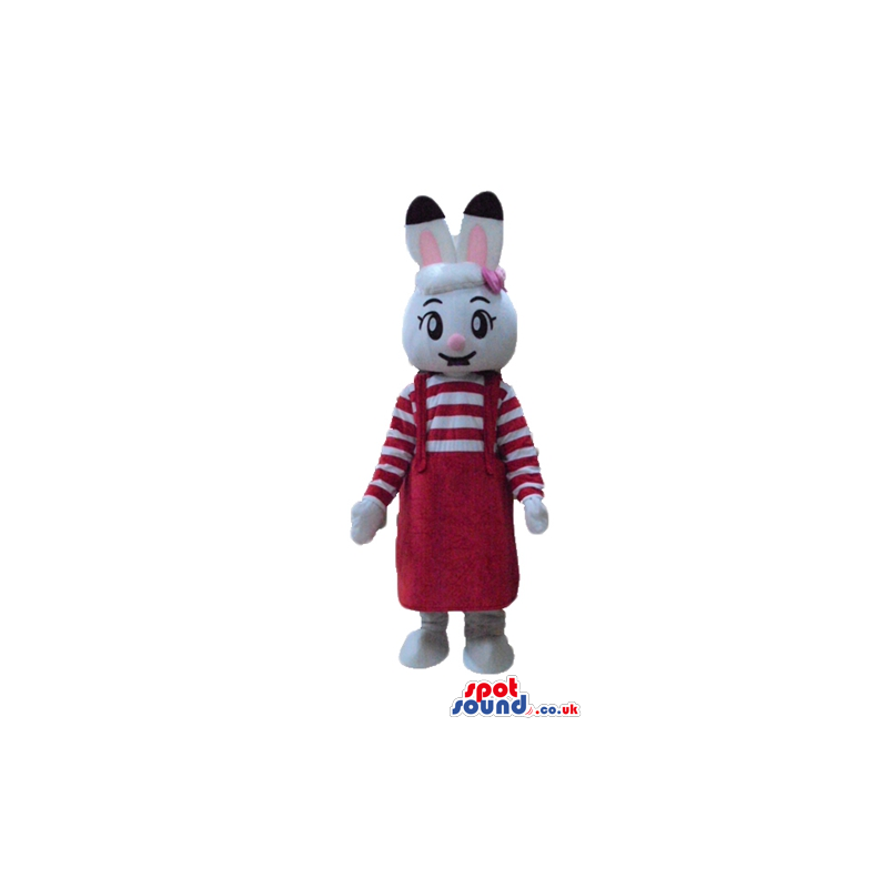 White rabbit with pink and black ears wearing a striped red and