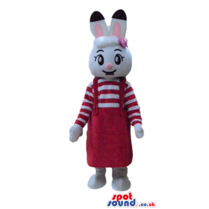 White rabbit with pink and black ears wearing a striped red and