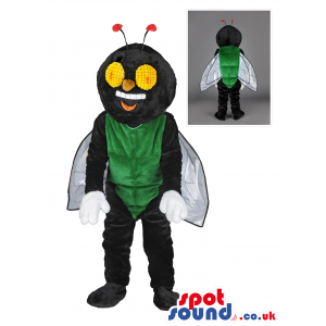 Black And Green Fly Mascot With Wings And Big Yellow Eyes.