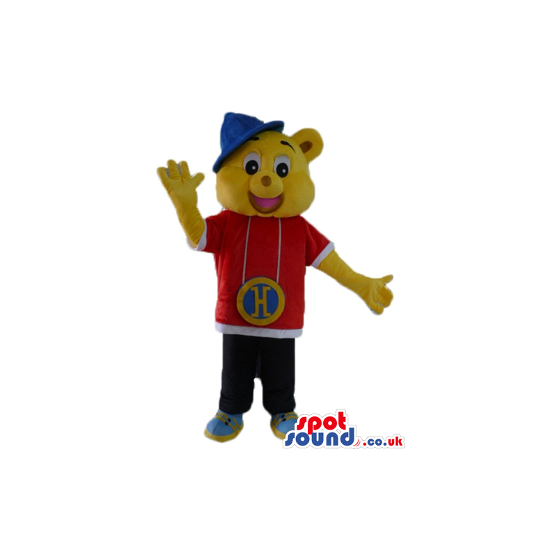 Yellow bear wearing a red and white shirt, black trousers, blue