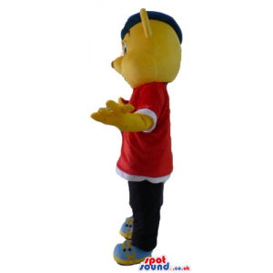 Yellow bear wearing a red and white shirt, black trousers, blue