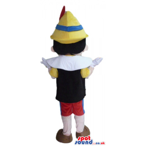 Pinocchio wearing a yellow shirt, a black vest, red trousers, a