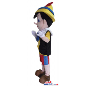 Pinocchio wearing a yellow shirt, a black vest, red trousers, a