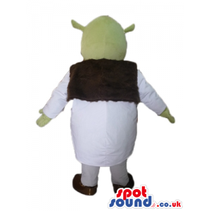 Green ogre wearing a white tunic and a brown furry vest -