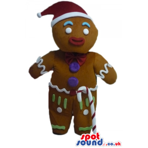 Gingerbread man colorfully decorated wearing a santa's hat and