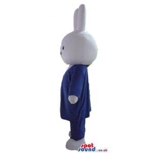 White rabbit wearing a blue suit, white shirt and red tie -