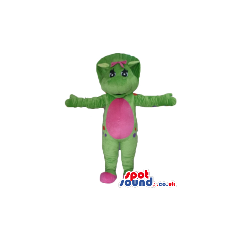 Green monster with freckles with a pink belly and a pink bow
