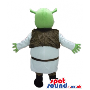 Green ogre wearing a white tunic and a brown furry vest and