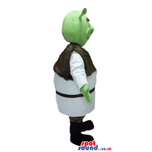 Green ogre wearing a white tunic and a brown furry vest and