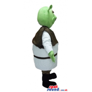 Green ogre wearing a white tunic and a brown furry vest and