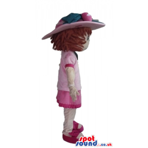 Brown-haired girl wearing a pink hat, a pink dress, white socks