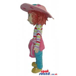 Girl wearing a pink hat, a striped t-shirt blue jeans and
