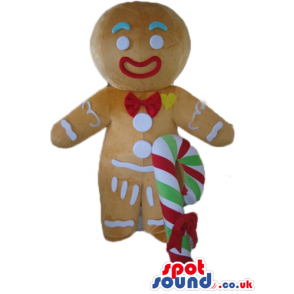 Gingerbread man colorfully decorated wearing a santa's hat and