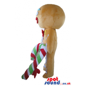 Gingerbread man colorfully decorated wearing a santa's hat and