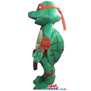 Ninja turtle wearing a red mask around the eyes and a red belt