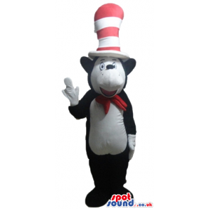 Black bear with a white belly wearing a red bow tie and a